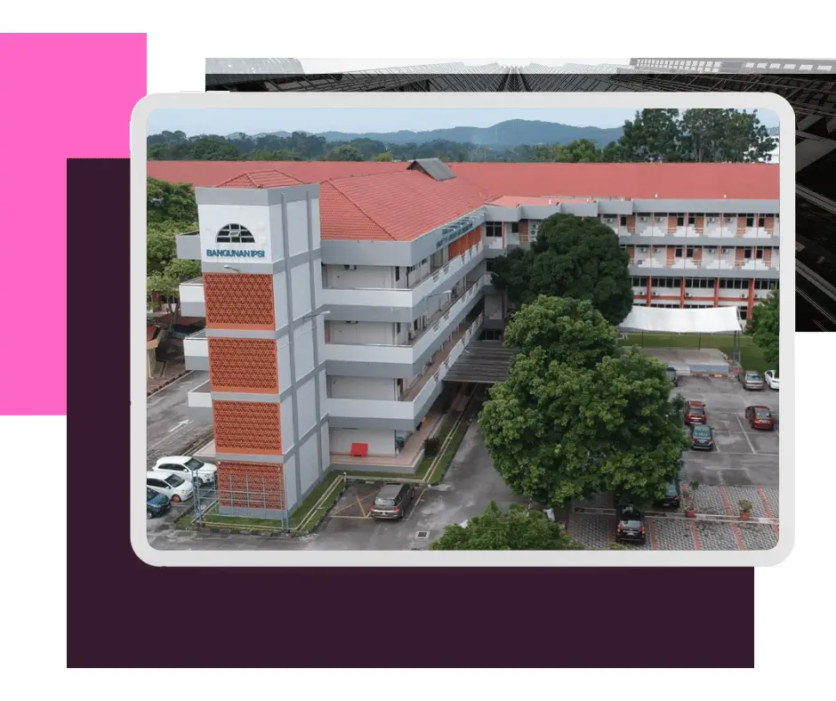 "Aerial view of the Faculty of Languages and Communication (FBC) building, a large three-story structure with a red roof, surrounded by trees and a parking lot."