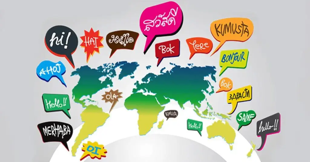 "A graphic representation of the world map surrounded by colorful speech bubbles containing various words and phrases in different global languages."